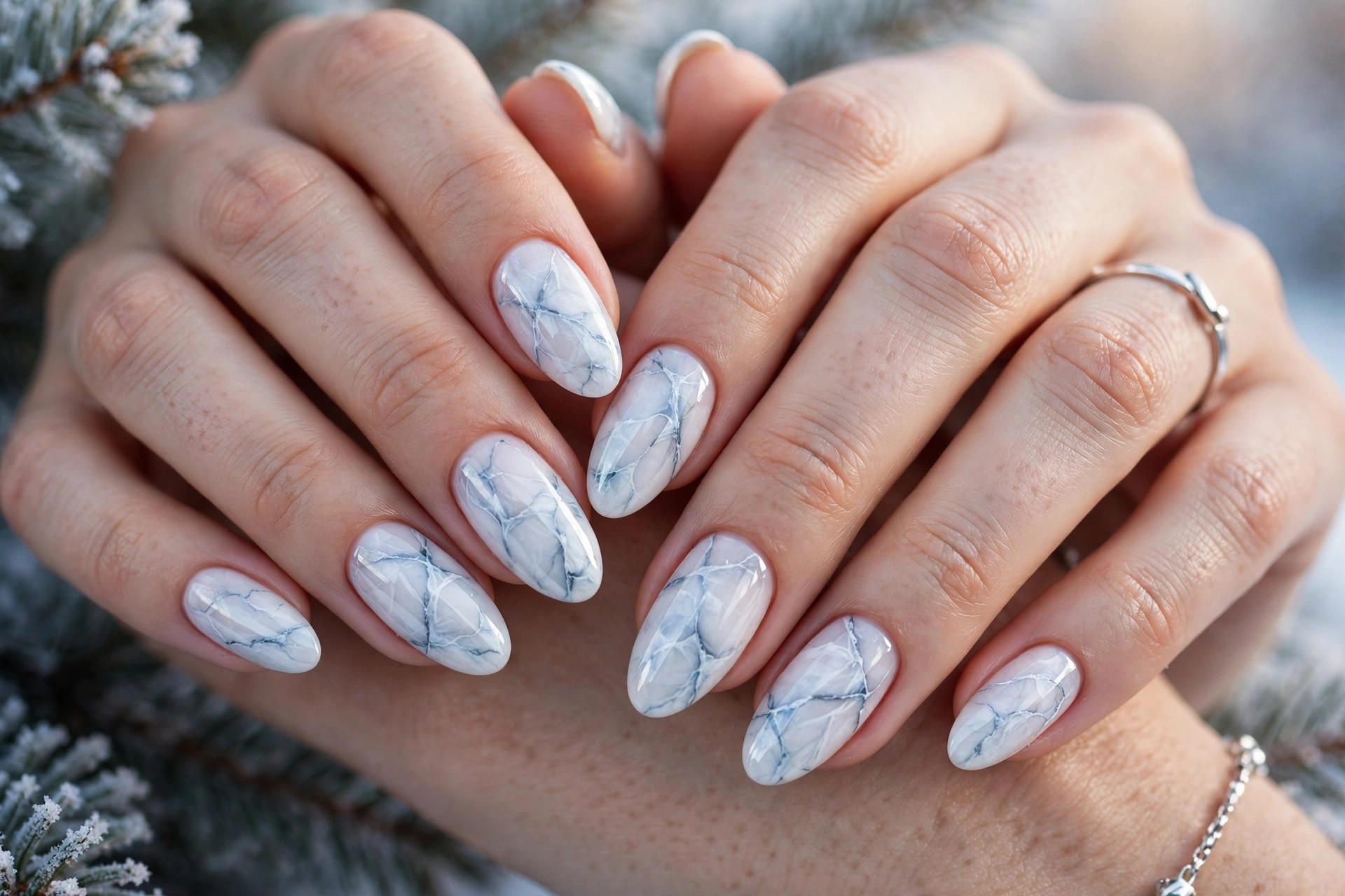 Frozen lake marble winter nails with ice-blue veining over a white base