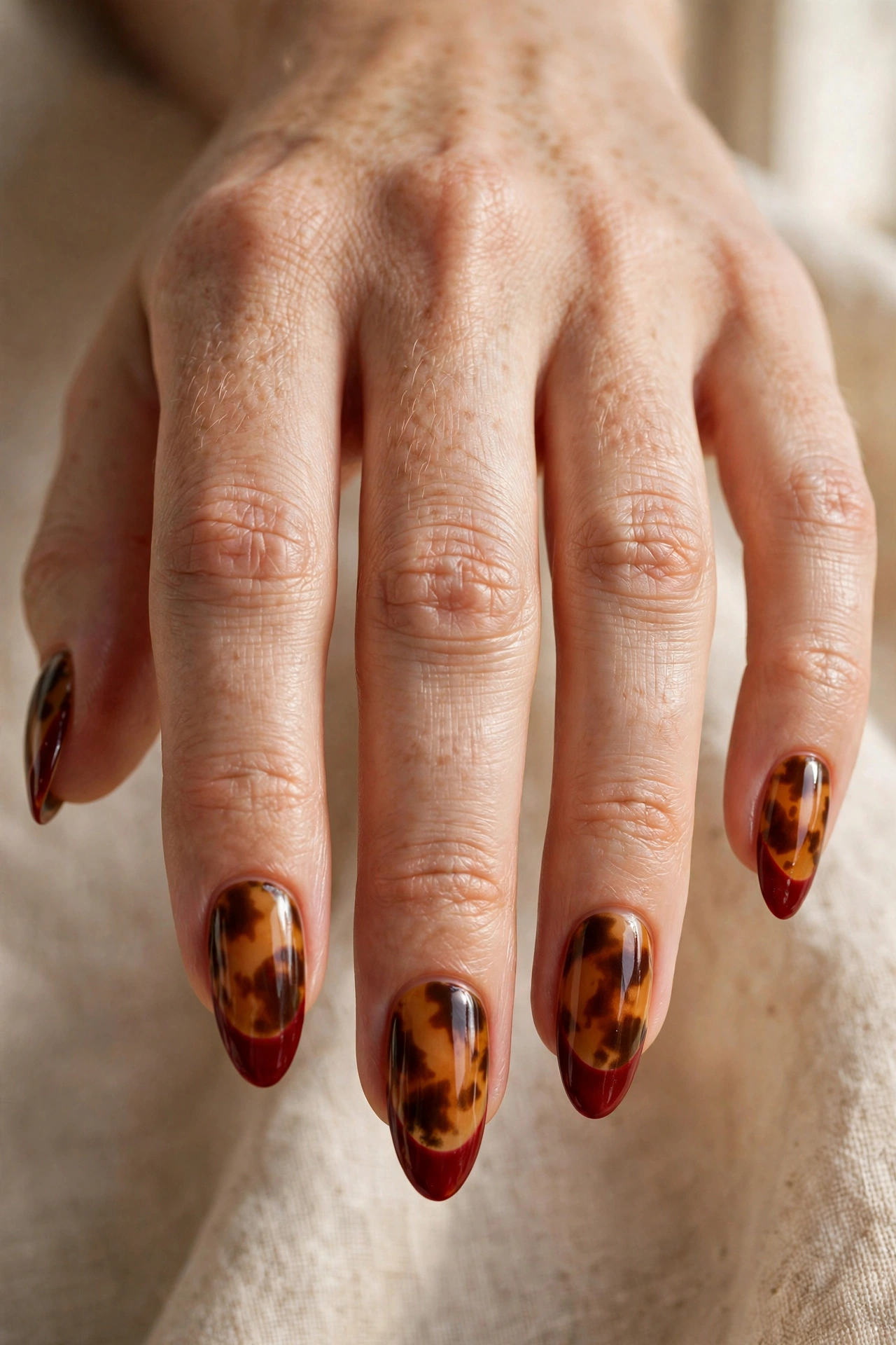 Tortoiseshell nails with bloody french tip halloween nail art on crimson tips