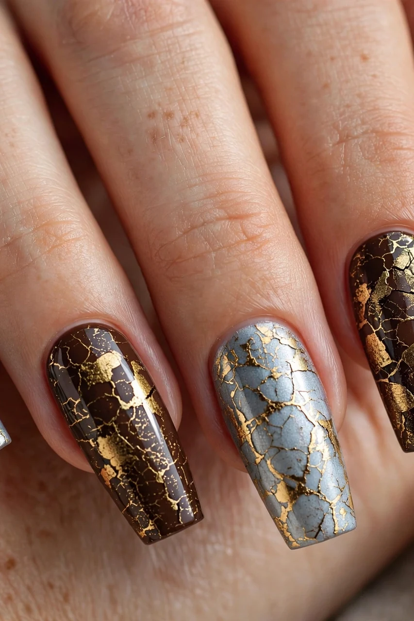 Crackle polish in icy blue and gold over espresso for glitchy glam Christmas nails