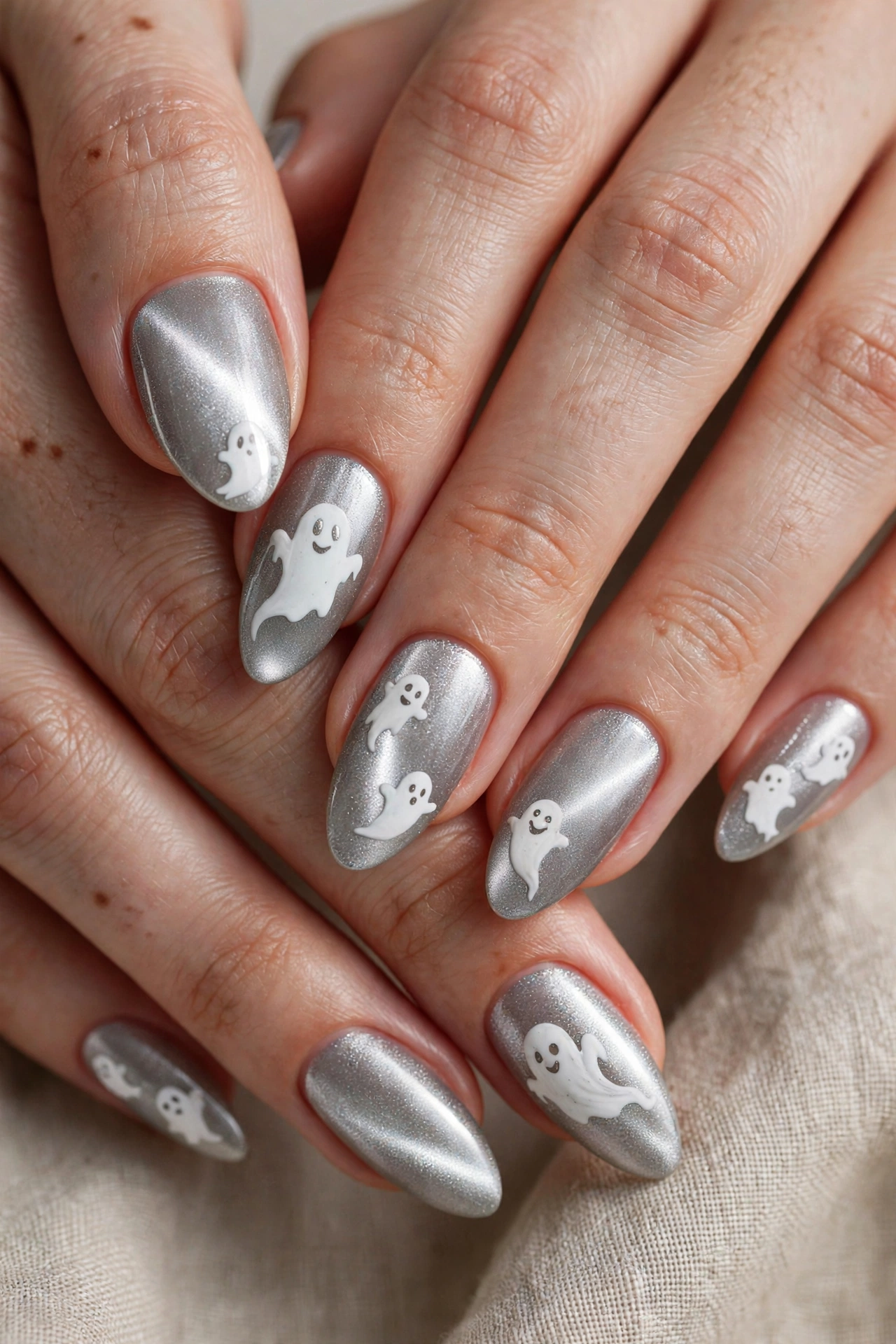 Silver cat eye ghost nail designs with moonlight Halloween manicure on real hands