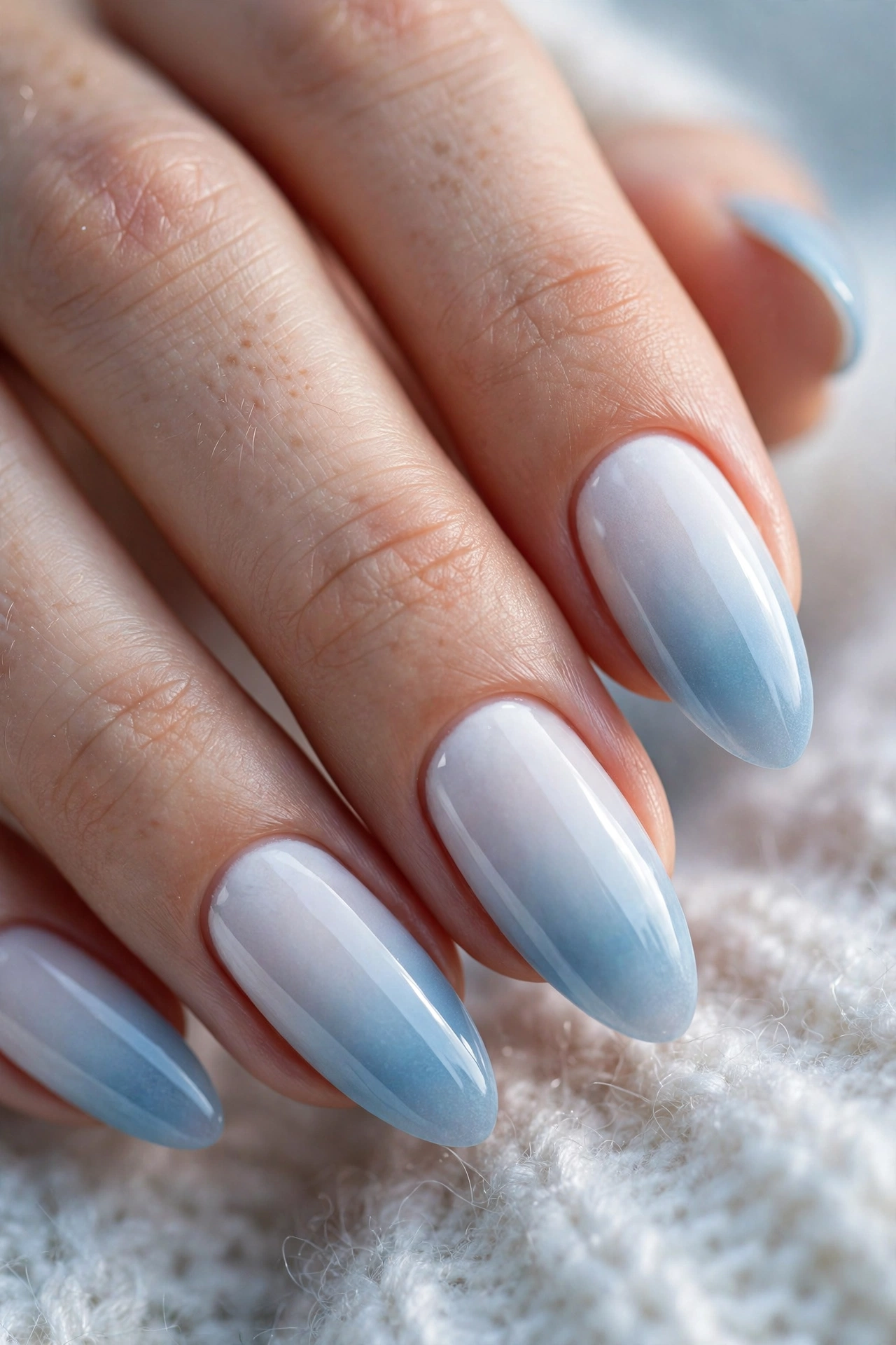 Frozen white to icy blue ombre Christmas nails with glossy gradient