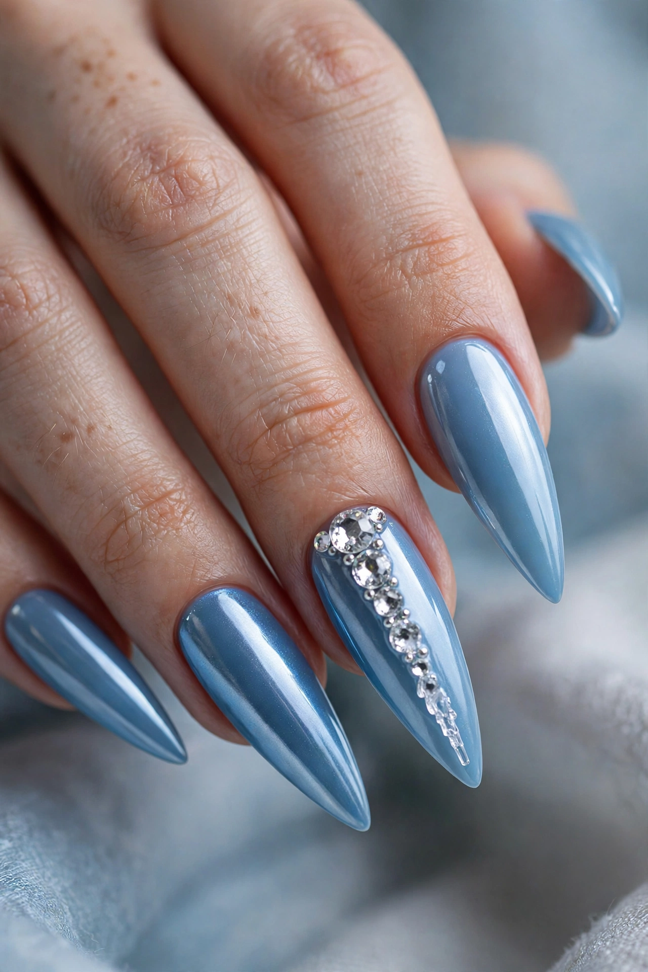 Icy blue stiletto Christmas nails with rhinestone icicle accents