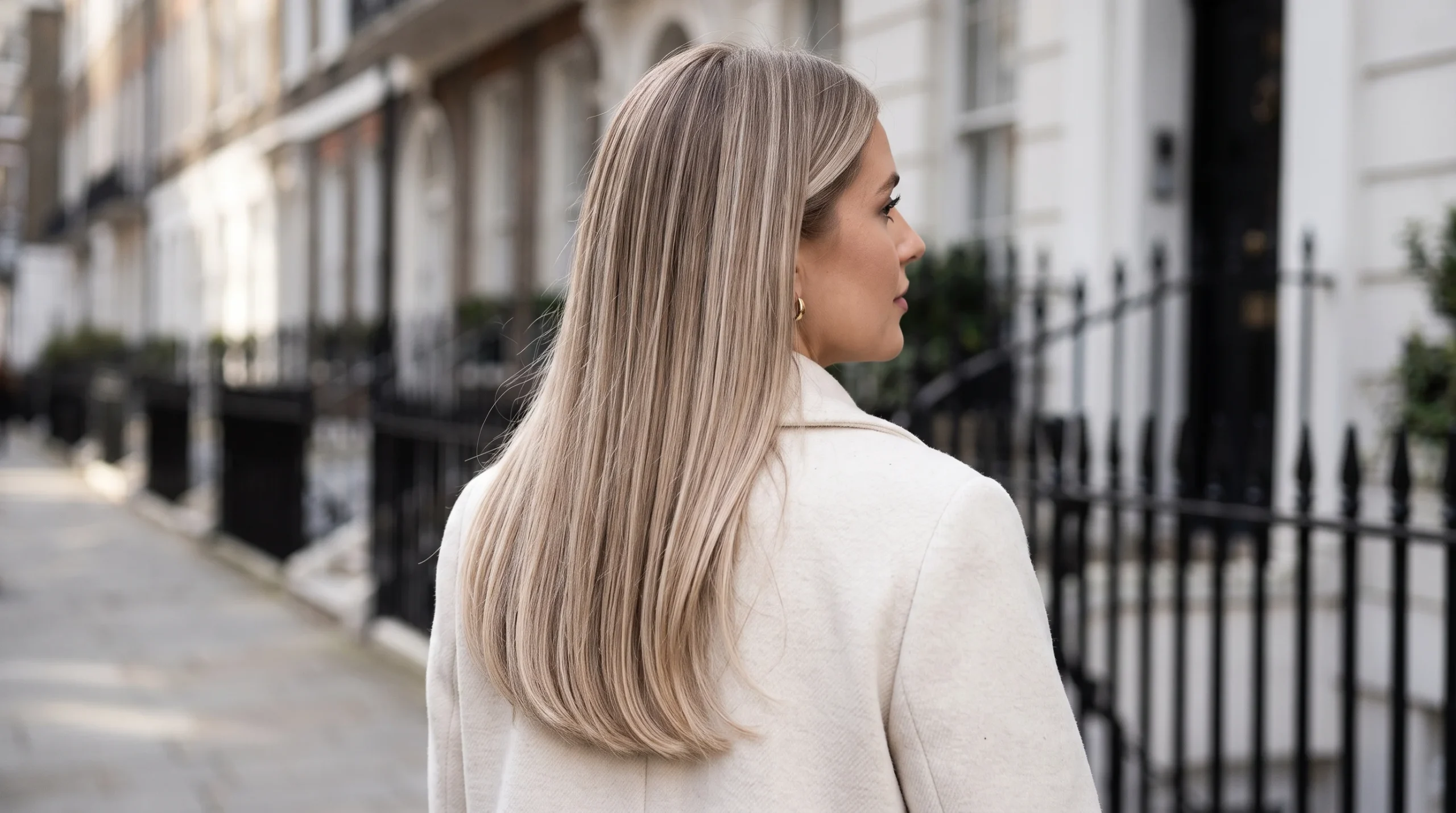 Champagne lived in blonde balayage, cool champagne ribbons hand-painted over a soft beige root